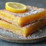 Vegan lemon bars with powdered sugar and lemon slices, perfect for gluten free dessert ideas | kaynmaytkal.com