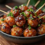 Dry gobi Manchurian skewers served in a bowl, coated in rich sauce and garnished with green onions | kaynmaytkal.com